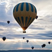 Experience a magical Turkey balloon ride in Cappadocia, soaring above fairy chimneys and valleys, witnessing breathtaking views in the morning sky